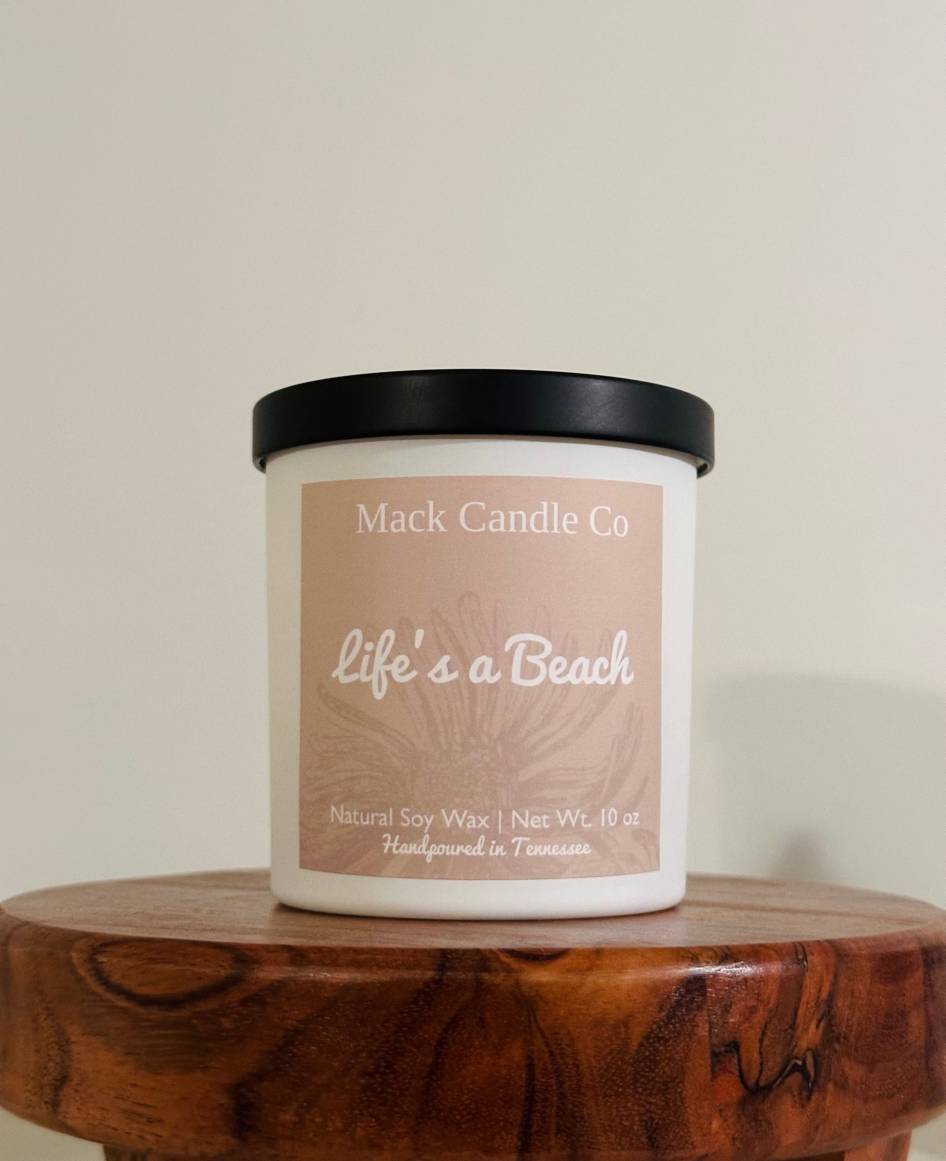 Luxury Life’s a beach Soy Candle, comes in a matte white jar filling the space of a bedroom. Non toxic clean burning handpoured in small batches in Nashville Tennessee. Smells like paradise!