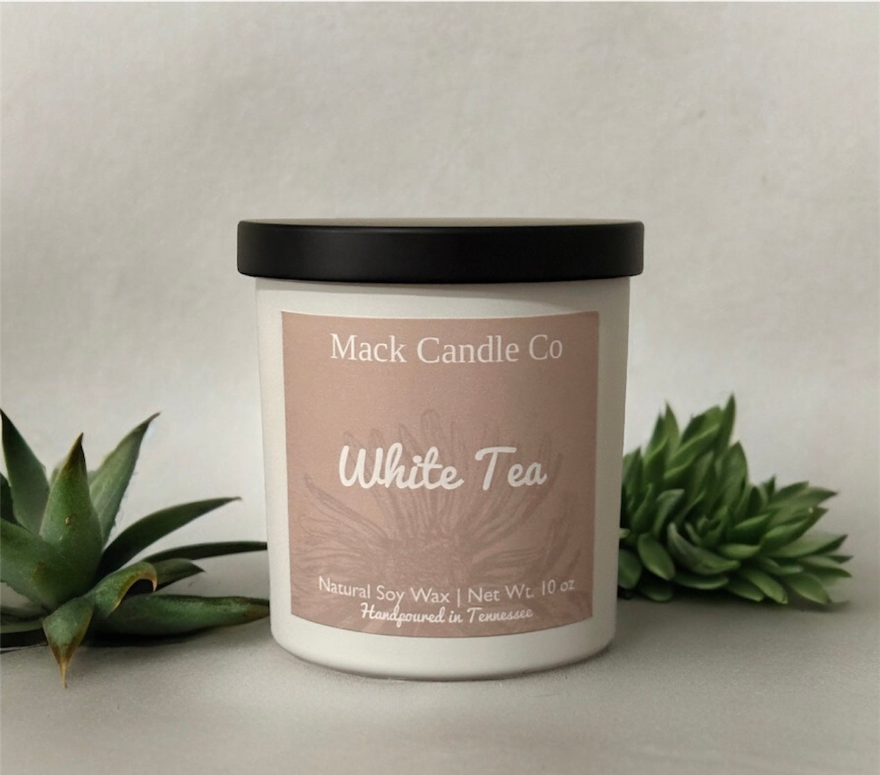 Luxury White Tea Soy Candle, comes in a white matte jar filling the space of a bedroom. Non toxic clean burning handpoured in small batches in Nashville Tennessee. 