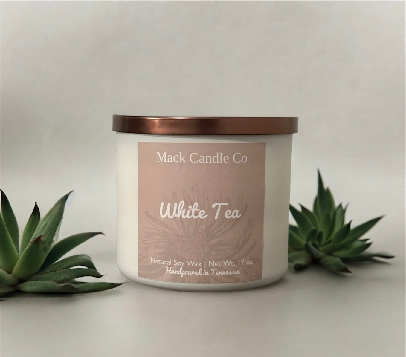 Luxury triple wick White Tea Soy Candle, comes in a matte white jar filling the space of a living room. Non toxic clean burning handpoured in small batches in Nashville Tennessee. 